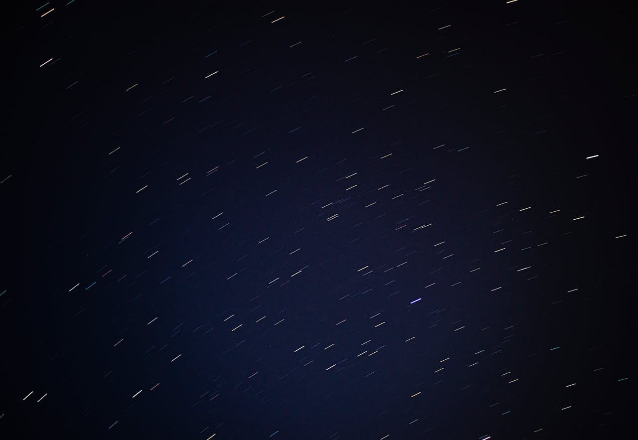 Mesmerizing star trails photograph taken at night showcasing the movement of stars across the dark sky.